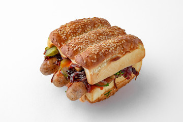 Huge hot dog burger with sausages from minced meat vegetables and herbs. For take away or food delivery isolated on a white background.
