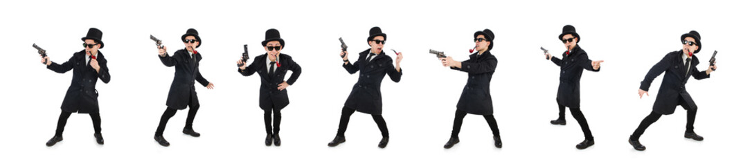 Young detective in black coat holding handgun isolated on white