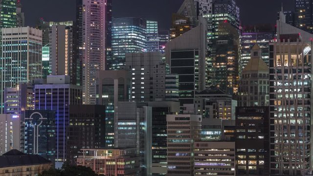 Aerial cityscape of Singapore downtown of modern architecture with illuminated skyscrapers night timelapse, view from above in chinatown district with glowing windows in towers