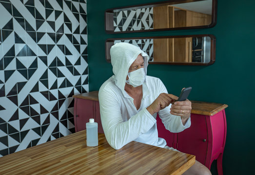 Coronavirus. Man quarantine at home with mobile.