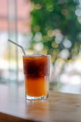Ice coffee, americano coffee with orange in cafe.