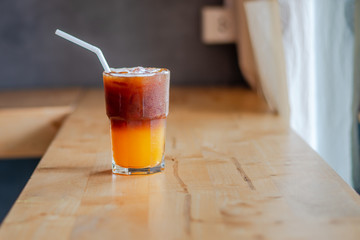Ice coffee, americano coffee with orange in cafe.