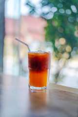 Ice coffee, americano coffee with orange in cafe.