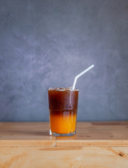Ice coffee, americano coffee with orange in cafe.