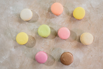 Macarons on a concrete background. Isolates. Multi-colored. Beautiful background.