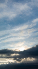 Fantastic clouds at sunrise, vertical panorama