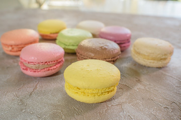 Macarons on a concrete background. Isolates. Multi-colored. Beautiful background.