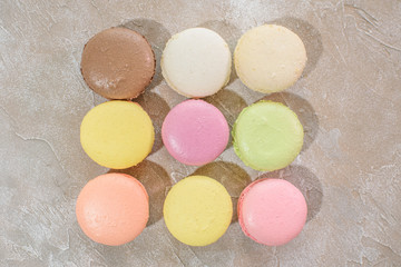 Macarons on a concrete background. Isolates. Multi-colored. Beautiful background.