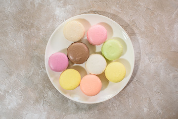 Colored macarons on a plate close-up. Delicious french food.
