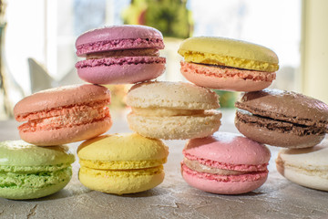 Macarons on a concrete background. Isolates. Multi-colored. Beautiful background.