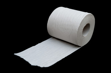 Single roll of unrolled white toilet paper. Isolated on black background. Close-up. Copy space. Horizontal shot.