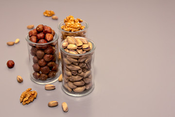 hazelnut, walnut and pistachio nut. mixed assorted nuts in glass box on light background.