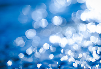 Abstract glare background on a blue background, bokeh background and texture for design