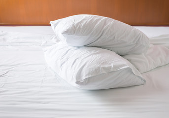 Fototapeta na wymiar White wrinkled pillows on the bed