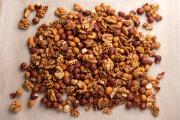 pile of mixed nuts on baking paper background