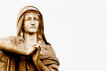 Fragment of ancient stone statue of Mary Magdalene praying. Faith, religion, God concept. Horizontal image.