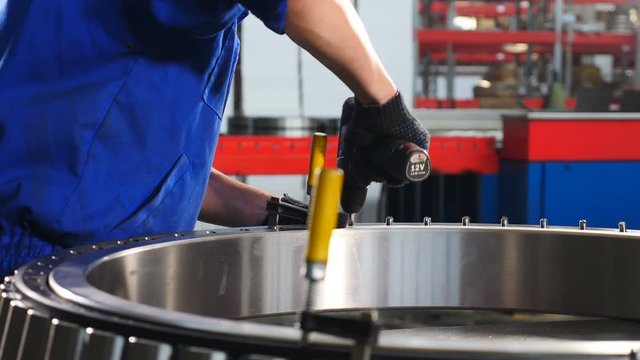 Industry and Machinery concept. Hand man labour. manufacture of bearings at factory. Bearing production and assembling Close up. 4k video
