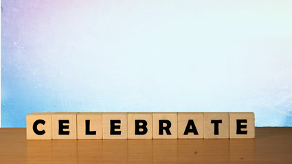 Celebrate message sign on a wooden desk on cube blocks