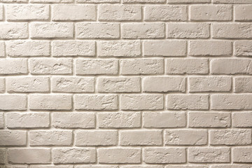 White brick textured wall with a slight yellow tint