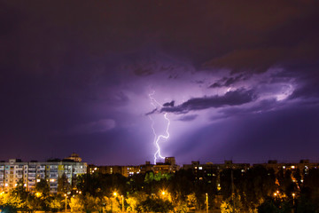 thunderstorm and lightning over the city at dark night