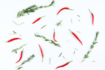 Rosemary and chili peppers on a white background, top view. Spices, seasonings