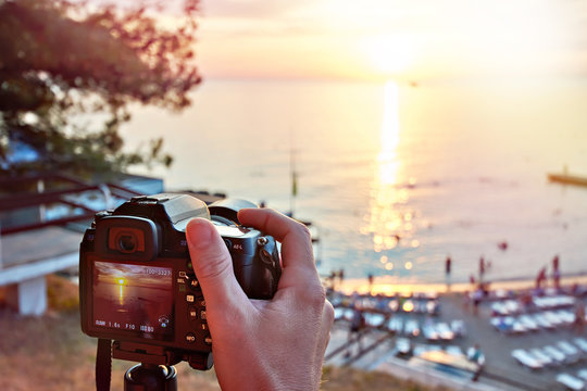 Photographer takes photos of beautiful sunset