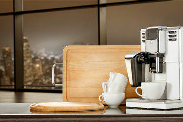 Coffee machine in office and blurred window of city at night 
