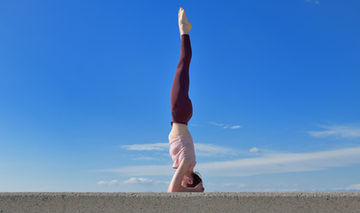 Portrait of a fit woman who practices yoga outdoors. Woman practicing asanas on a sunny day