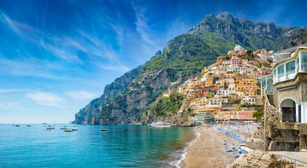 Beautiful Positano with colorful architecture on hills leading down to coast, comfortable beaches and azure sea on Amalfi Coast in Campania, Italy.