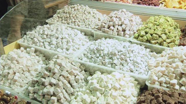 Turkish delight for dessert. Lokum dish with kiwi flavor on sale in Istanbul food store.Traditional sweet locum with sugar for snack