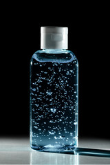 Bottle of instant antiseptic hand sanitizer transparent gel isolated on black background, no label.
