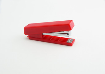 red office stapler on a white background