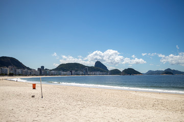 Near empty Copacabana beach with the Sugarloaf mountain in the background during the COVID-19 Corona virus outbreak in Rio de Janeiro, Brazil