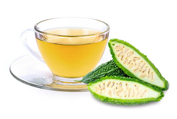 Closeup glass cup bitter gourd juice tea with bittergound slice isolated on white background. Herbal medicine plant and healthy drinks concept.