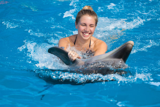 Girl swimming with dolphin