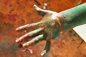 Hands of a child in paint playing on the Sun in the time of isolation background. 