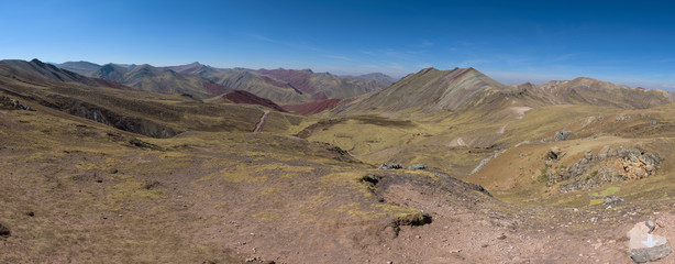 Lush green and red valleys around the Palccoyo Rainbow Mountains, Peru