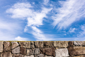 Stone wall with blue sky background