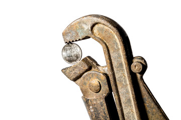 The ruble coin is clamped with a wrench  on a white background