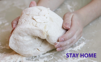 Stay at home quarantine coronavirus pandemic prevention. Making dough from flour. The child kneads the dough closeup