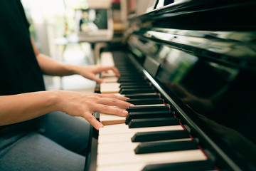 Scene of piano lessons online training or E-class learning while Coronavirus spread out or covid-19 crisis situation, vlog or teacher make online piano lesson to teach students pupils learn from home.