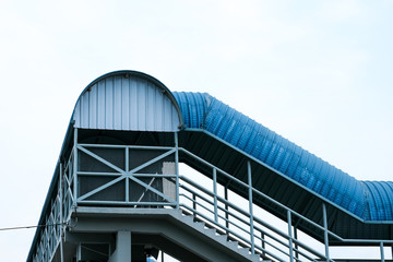 Fototapeta premium Low angle photo of pedestrian bridge in Port Klang.