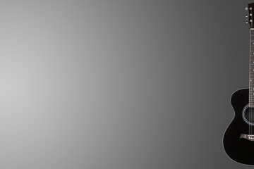 Acoustic guitar on grey graduated background with copy space