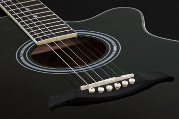 Fototapeta premium Body of black electric acoustic guitar on dark background