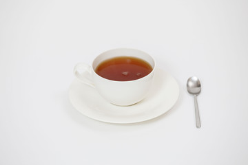 white cup with tea on a white background
