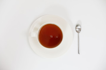 white cup with tea on a white background