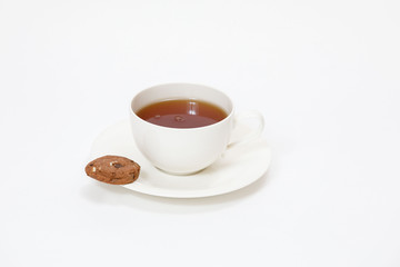 white cup with tea and cookies on a white background