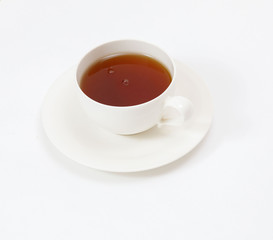 white cup with tea on a white background