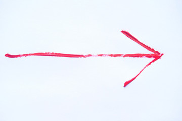 Red hand painted arrow with brush strokes isolated on the white background.