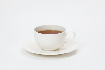 white cup with tea on a white background
